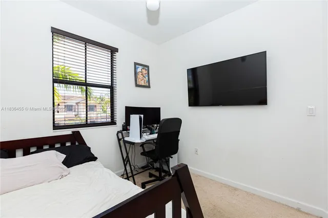 a livingroom with lounge chair and a flat screen tv