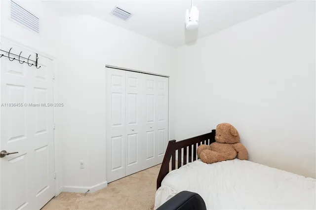 a bedroom with a bed and a chandelier fan