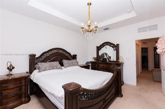 a bedroom with a bed and a potted plant