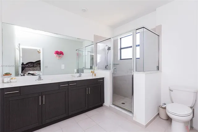 a spacious bathroom with a granite countertop sink mirror and toilet