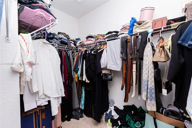 a view of walk in closet with clothes