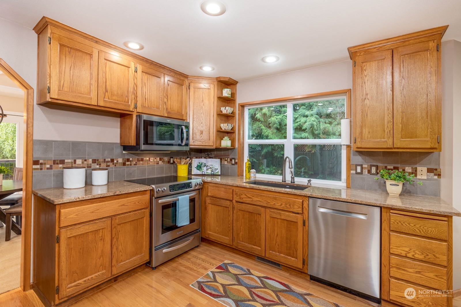2415 Viewcrest Avenue Everett, WA 98203 - Photo 18 of 37 a kitchen with a sink stove and microwave