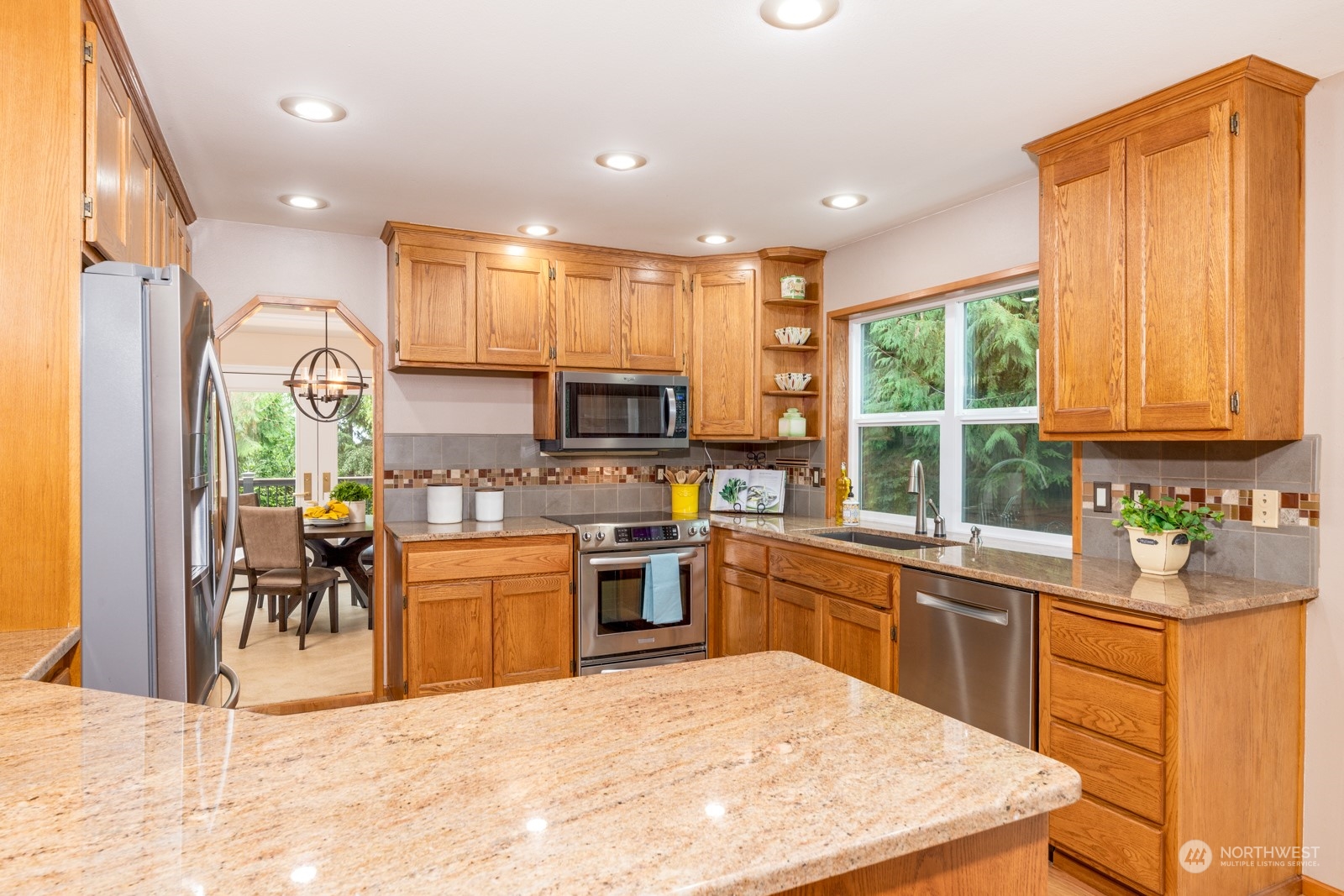 2415 Viewcrest Avenue Everett, WA 98203 - Photo 19 of 37 a kitchen with a sink a counter top space appliances and cabinets