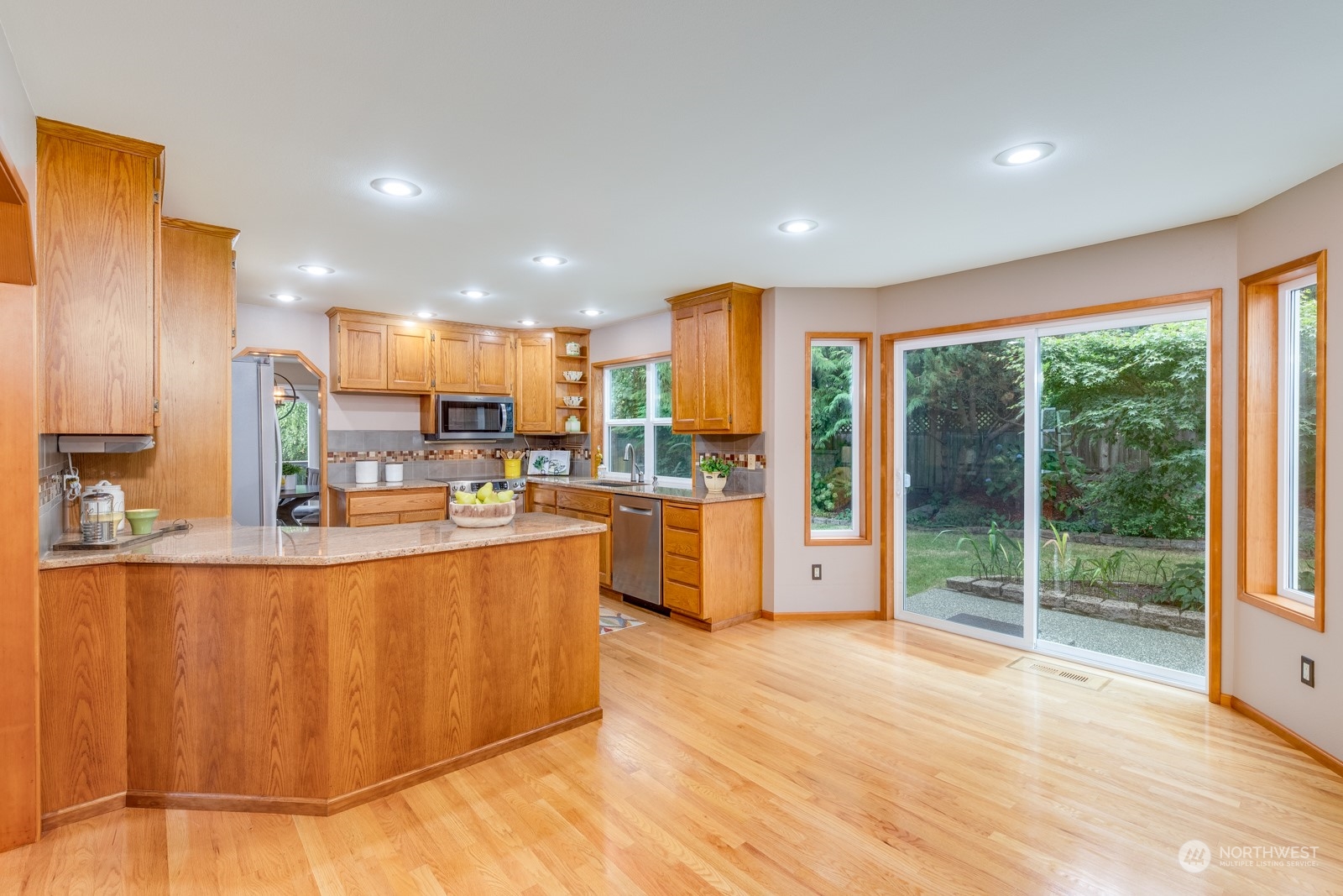 2415 Viewcrest Avenue Everett, WA 98203 - Photo 21 of 37 a view of kitchen with stainless steel appliances granite countertop a stove a sink dishwasher and a refrigerator with wooden floor