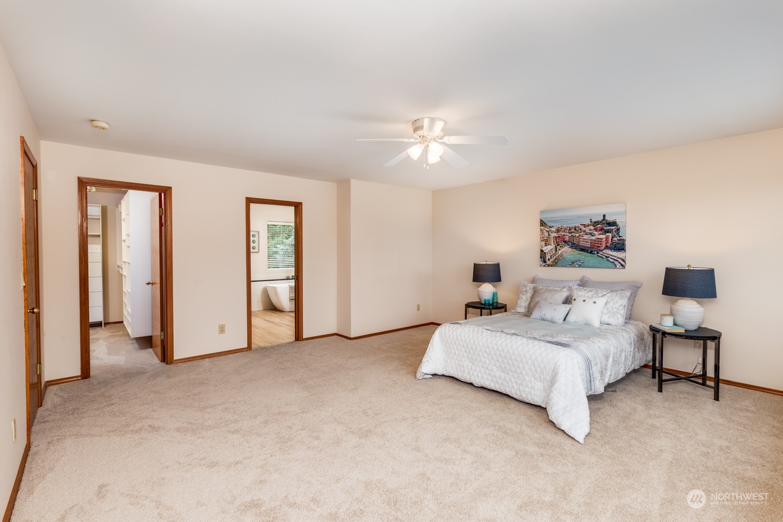 2415 Viewcrest Avenue Everett, WA 98203 - Photo 25 of 37 a spacious bedroom with a bed and a chandelier