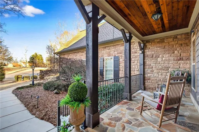 a kitchen with stainless steel appliances granite countertop a sink a stove and a wooden floors
