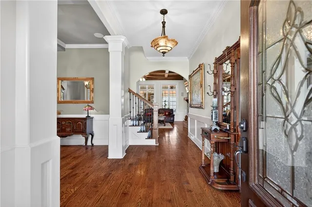 a bedroom with a large bed and a chandelier fan