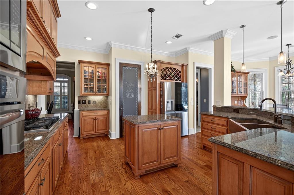 18 Willow Place Newnan, GA 30265 - Photo 38 of 130 a kitchen with stainless steel appliances granite countertop a refrigerator a sink dishwasher a stove and white countertops with wooden floor