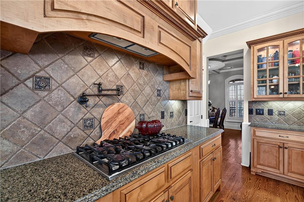 18 Willow Place Newnan, GA 30265 - Photo 39 of 130 a kitchen with stainless steel appliances granite countertop a stove and cabinets