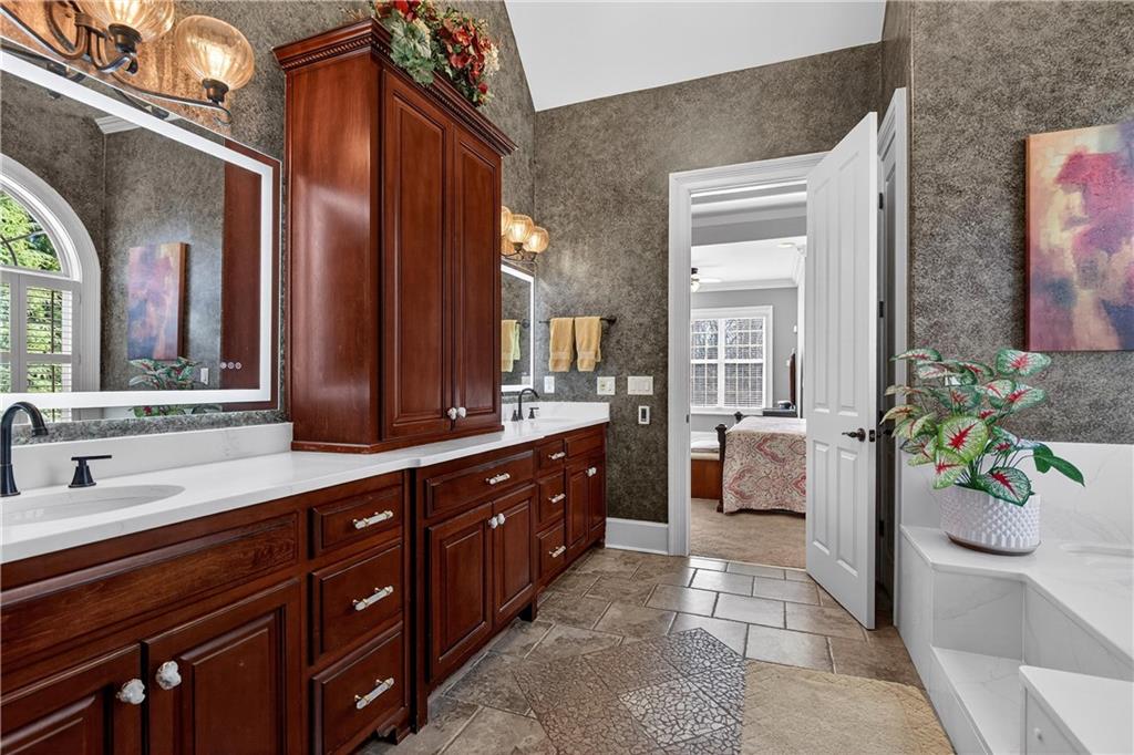 18 Willow Place Newnan, GA 30265 - Photo 55 of 130 a spacious en suite bathroom with a granite countertop sink and a mirror