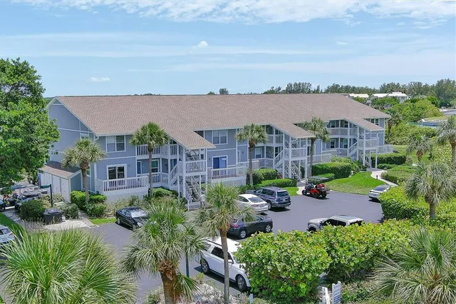 an aerial view of a house with garden space and lake view