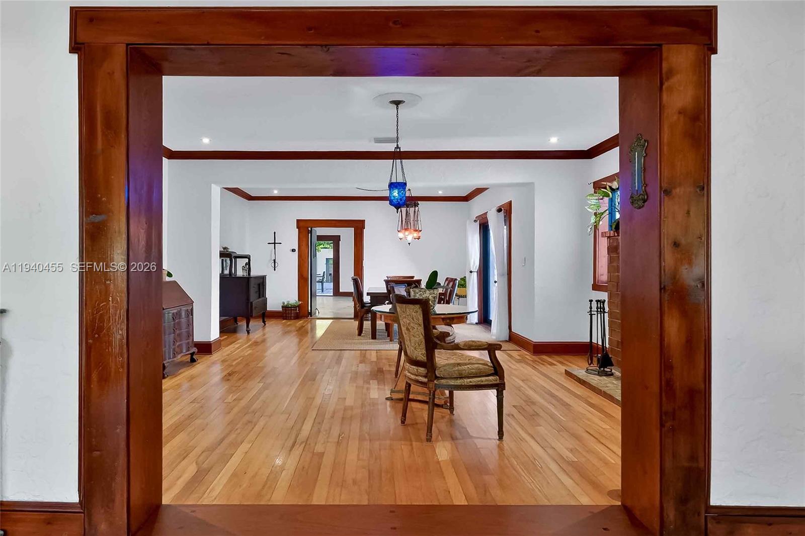 452 Southwest 21st Road Miami, FL 33129 - Photo 6 of 51 a view of a livingroom with furniture a ceiling fan and wooden floor
