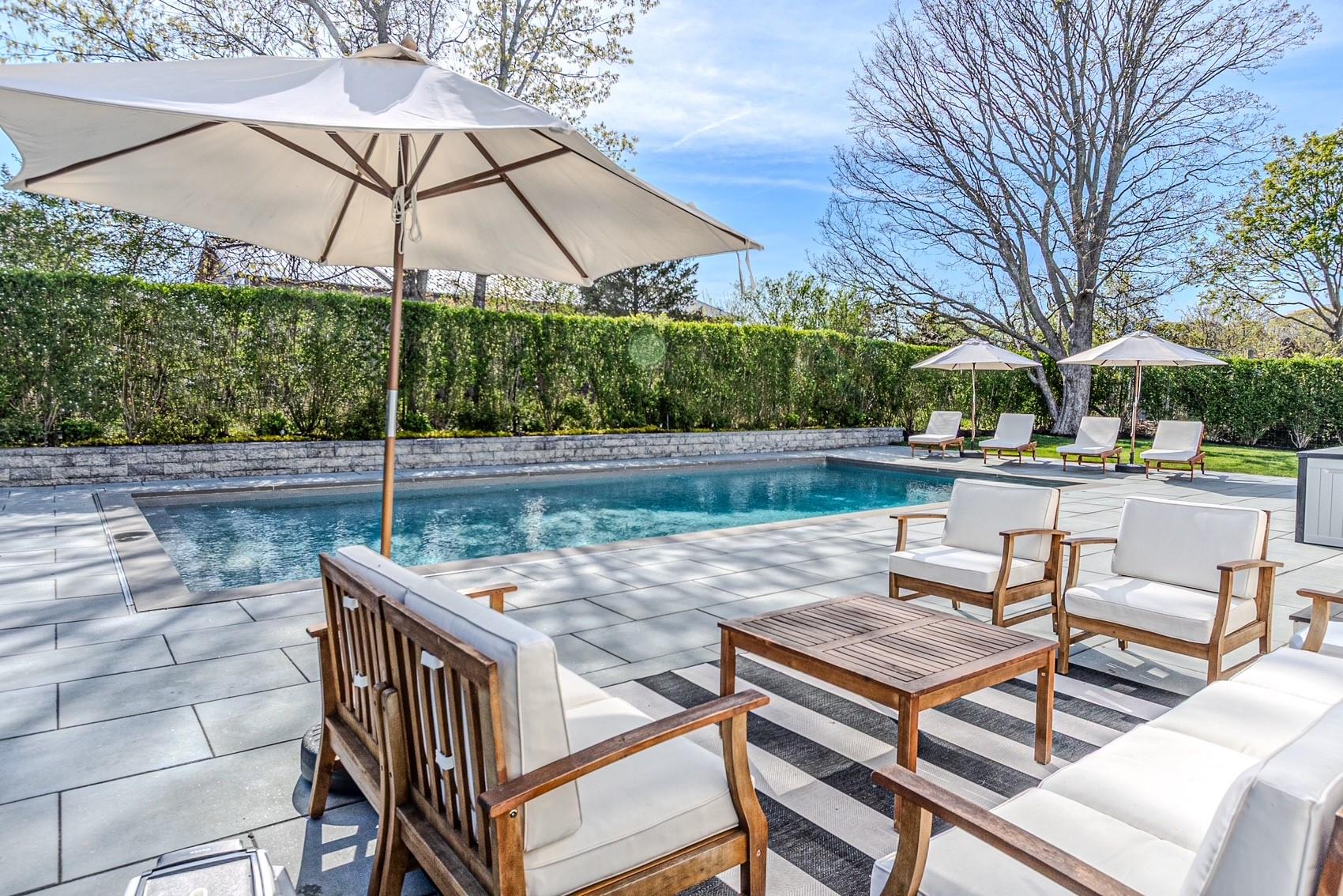 3200 Bay Shore Road Greenport, NY 11944 - Photo 1 of 1 a view of a patio with table and chairs under an umbrella