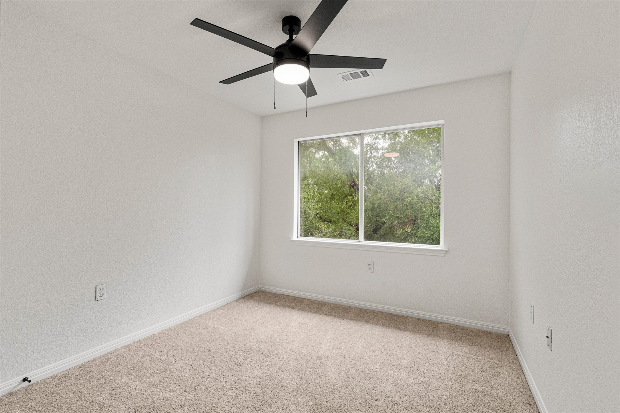 3003 Glen Rae Street Austin, TX 78702 - Photo 26 of 38 Like the primary suite, each guest bedroom benefits from large windows looking out into the dense, mature tree canopy, continuing the treehouse aesthetic throughout the upper level