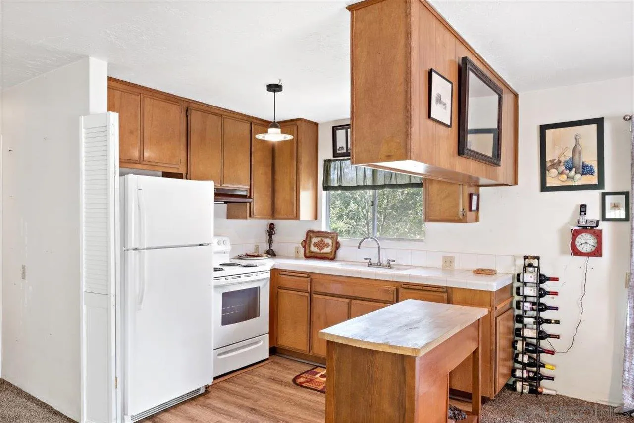 808 Pine Cone Drive Julian, CA 92036 - Photo 11 of 23 a kitchen with a sink stove and refrigerator