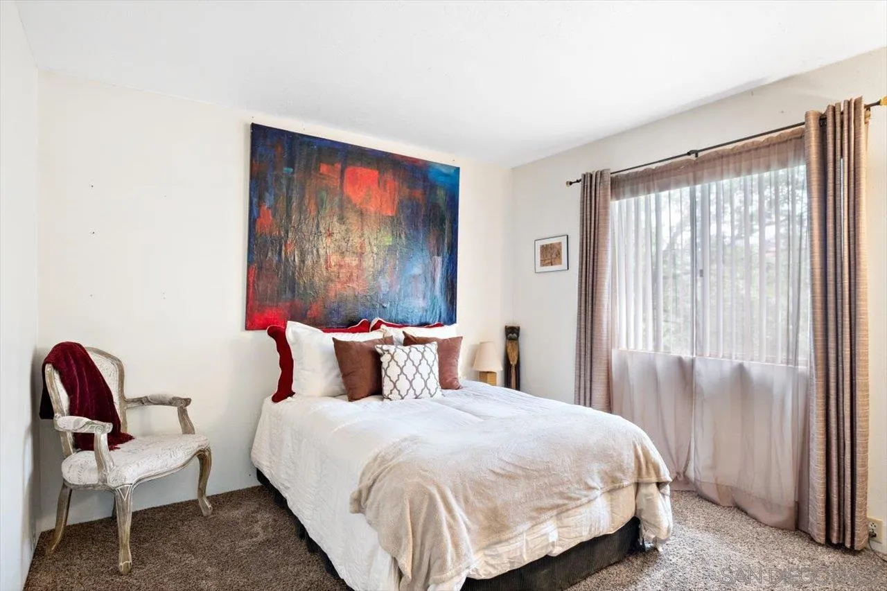 808 Pine Cone Drive Julian, CA 92036 - Photo 17 of 23 a bedroom with a bed and a chair