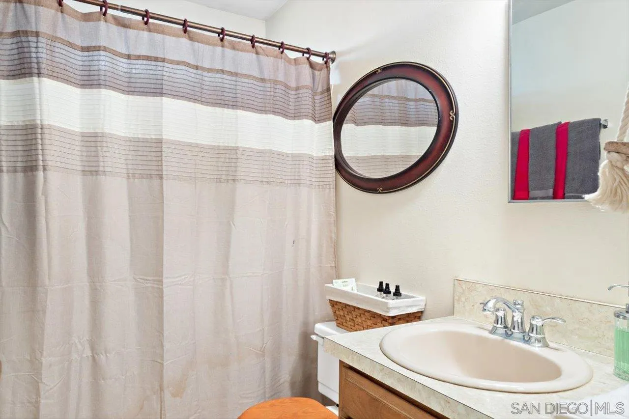 808 Pine Cone Drive Julian, CA 92036 - Photo 21 of 23 a bathroom with a sink and a mirror