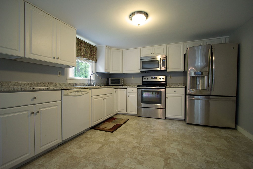 55 Garrison Road Shirley, MA 01464 - Photo 3 of 9 a kitchen with cabinets stainless steel appliances and a counter top space