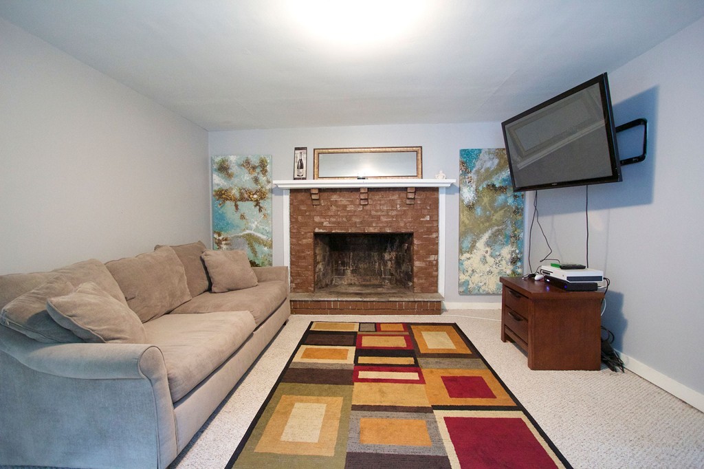 55 Garrison Road Shirley, MA 01464 - Photo 4 of 9 a living room with furniture and a fireplace