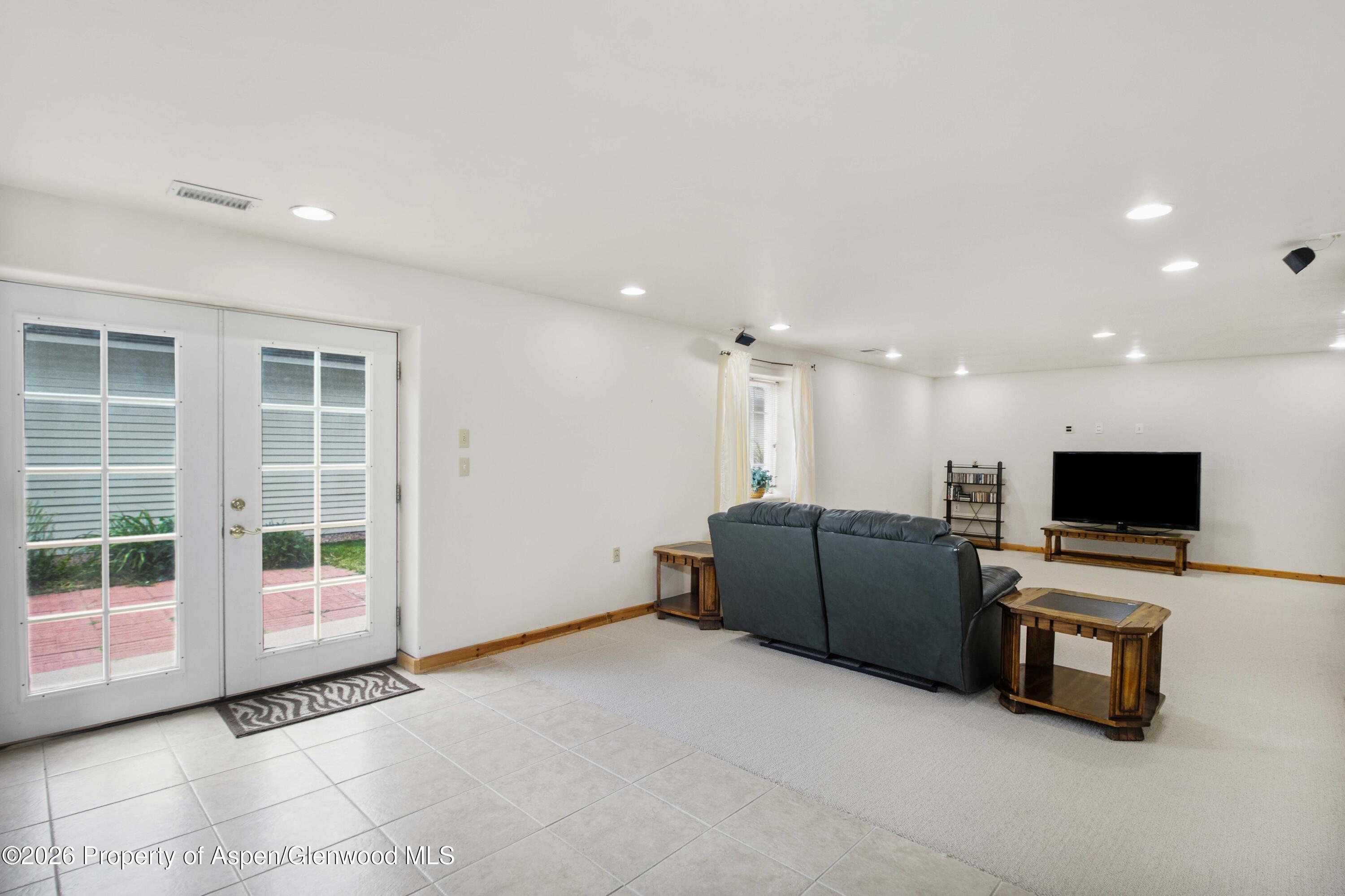 660 Aspen Avenue Rifle, CO 81650 - Photo 20 of 30 a living room with furniture and a flat screen tv