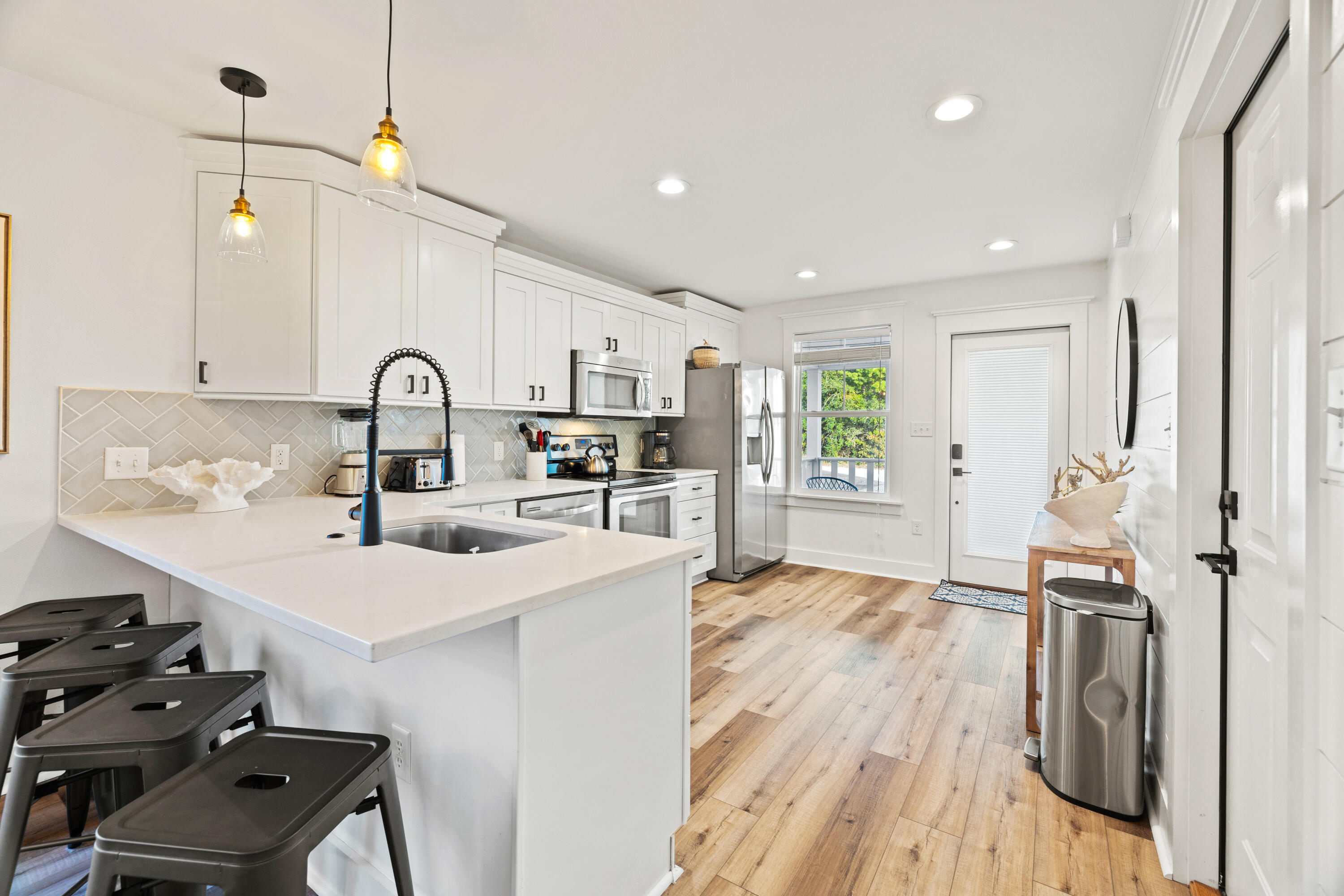 65 Brown Street Santa Rosa Beach, FL 32459 - Photo 12 of 43 a kitchen with sink cabinets and wooden floor