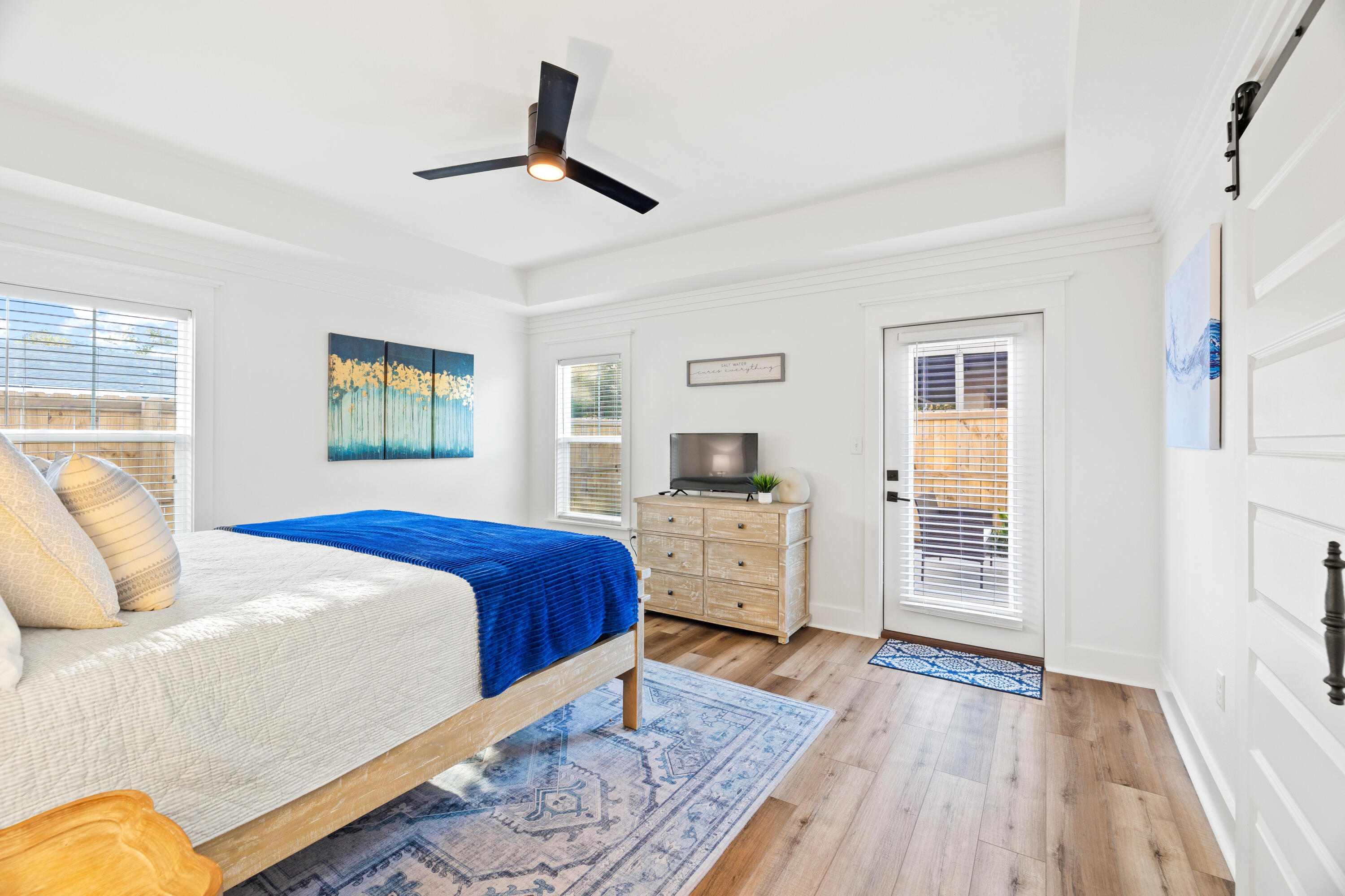 65 Brown Street Santa Rosa Beach, FL 32459 - Photo 15 of 43 a bedroom with a bed and wooden floor