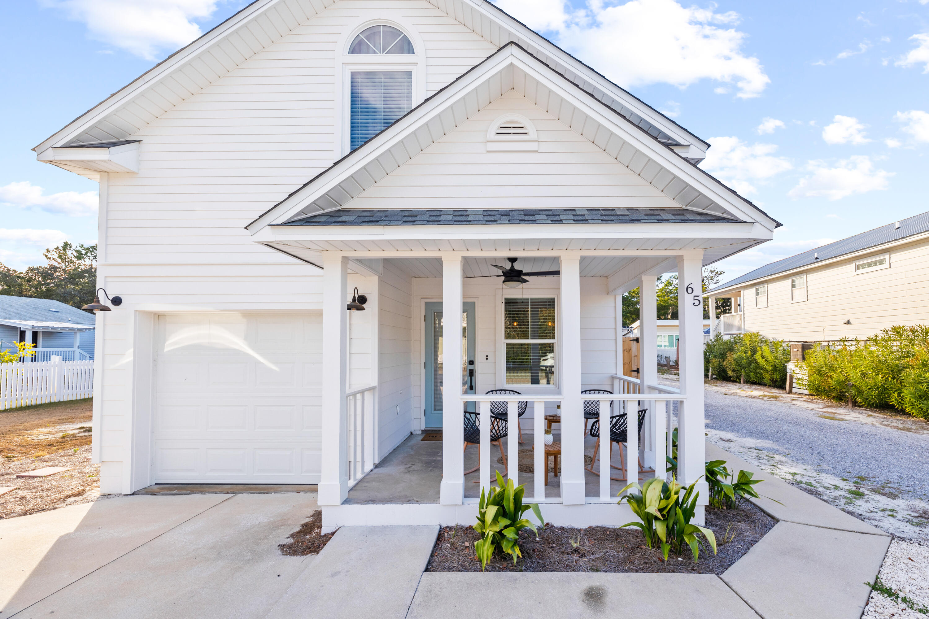 65 Brown Street Santa Rosa Beach, FL 32459 - Photo 2 of 43 a front view of a house with garden
