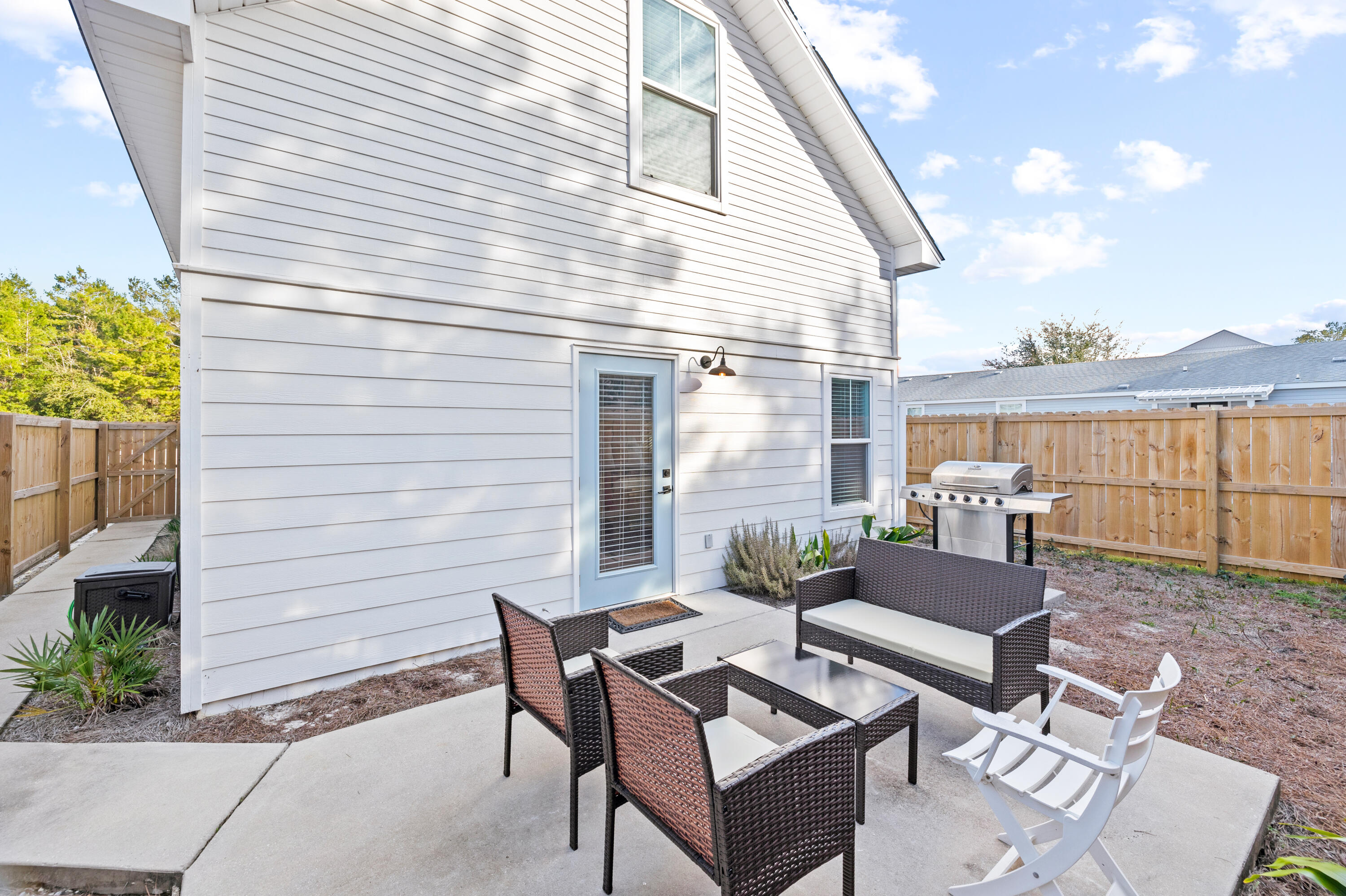 65 Brown Street Santa Rosa Beach, FL 32459 - Photo 33 of 43 a view of a patio with couches table and chairs and potted plants