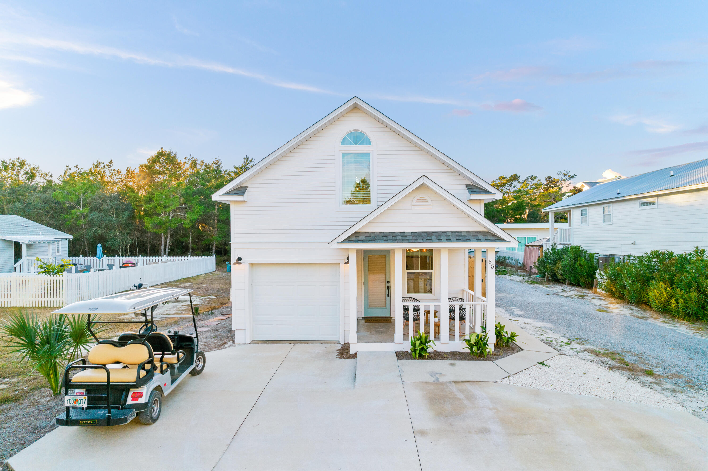 65 Brown Street Santa Rosa Beach, FL 32459 - Photo 39 of 43 a view of a white house next to a road and yard