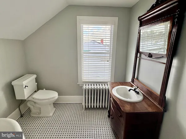 a bathroom with a sink toilet a mirror and shower