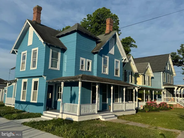 front view of brick house with a yard