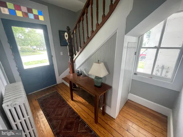 a view of an entryway with wooden floor