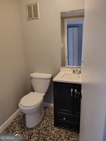 a bathroom with a toilet a sink and a window