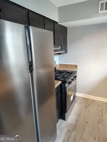a kitchen with stainless steel appliances a refrigerator and a stove