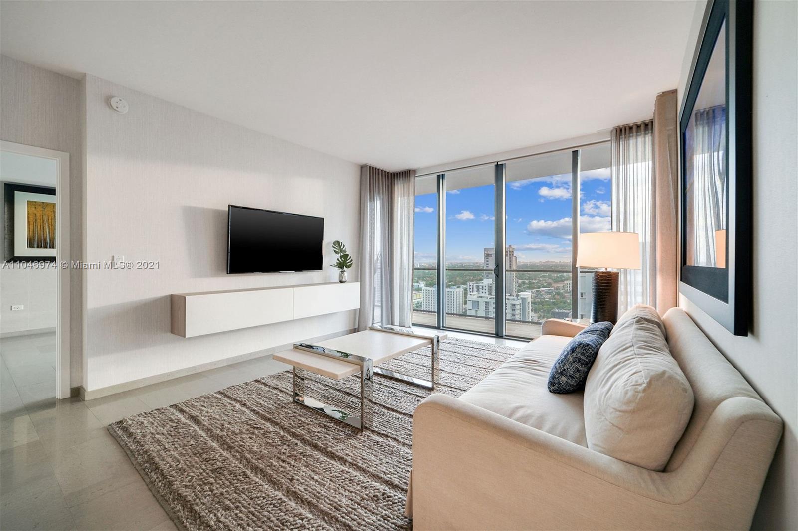88 Southwest 7th Street, Unit 1904 Miami, FL 33130 - Photo 1 of 28 a living room with furniture and a flat screen tv