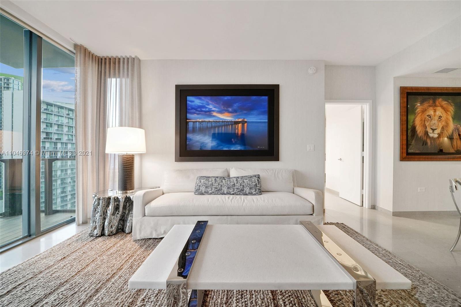 88 Southwest 7th Street, Unit 1904 Miami, FL 33130 - Photo 11 of 28 a living room with furniture and a lamp