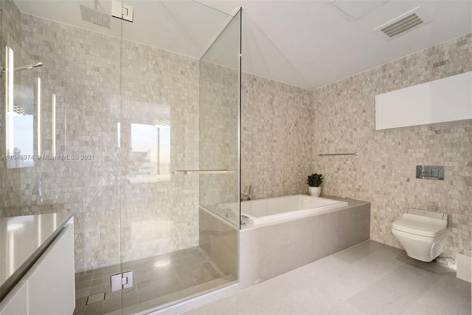 88 Southwest 7th Street, Unit 1904 Miami, FL 33130 - Photo 20 of 28 a bathroom with a sink a toilet a bathtub and shower