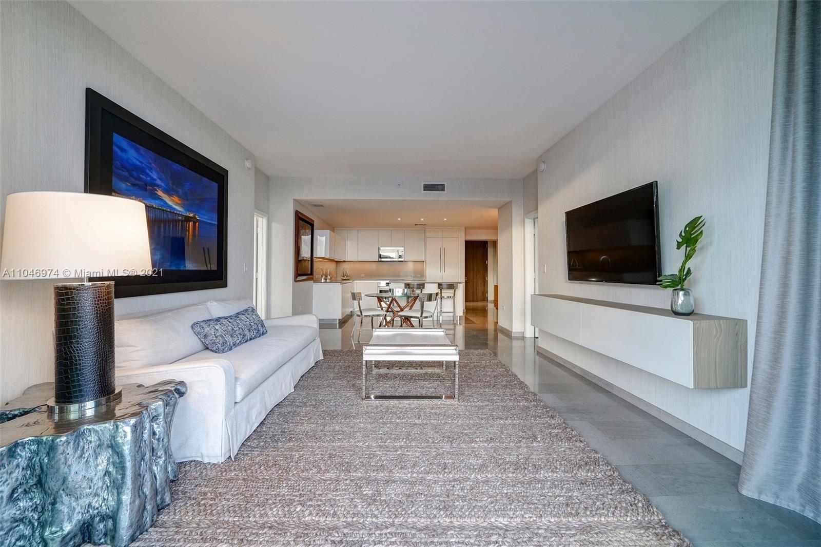 88 Southwest 7th Street, Unit 1904 Miami, FL 33130 - Photo 2 of 28 a living room with furniture and a flat screen tv