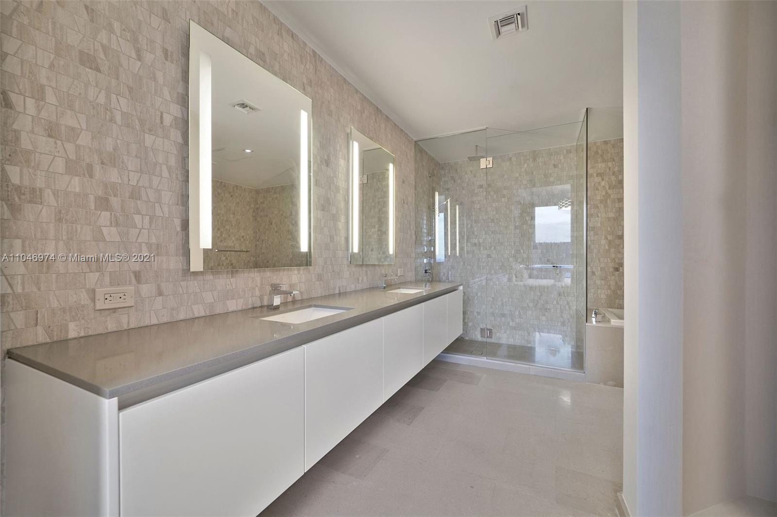 88 Southwest 7th Street, Unit 1904 Miami, FL 33130 - Photo 21 of 28 a large bathroom with a granite countertop sink and a mirror