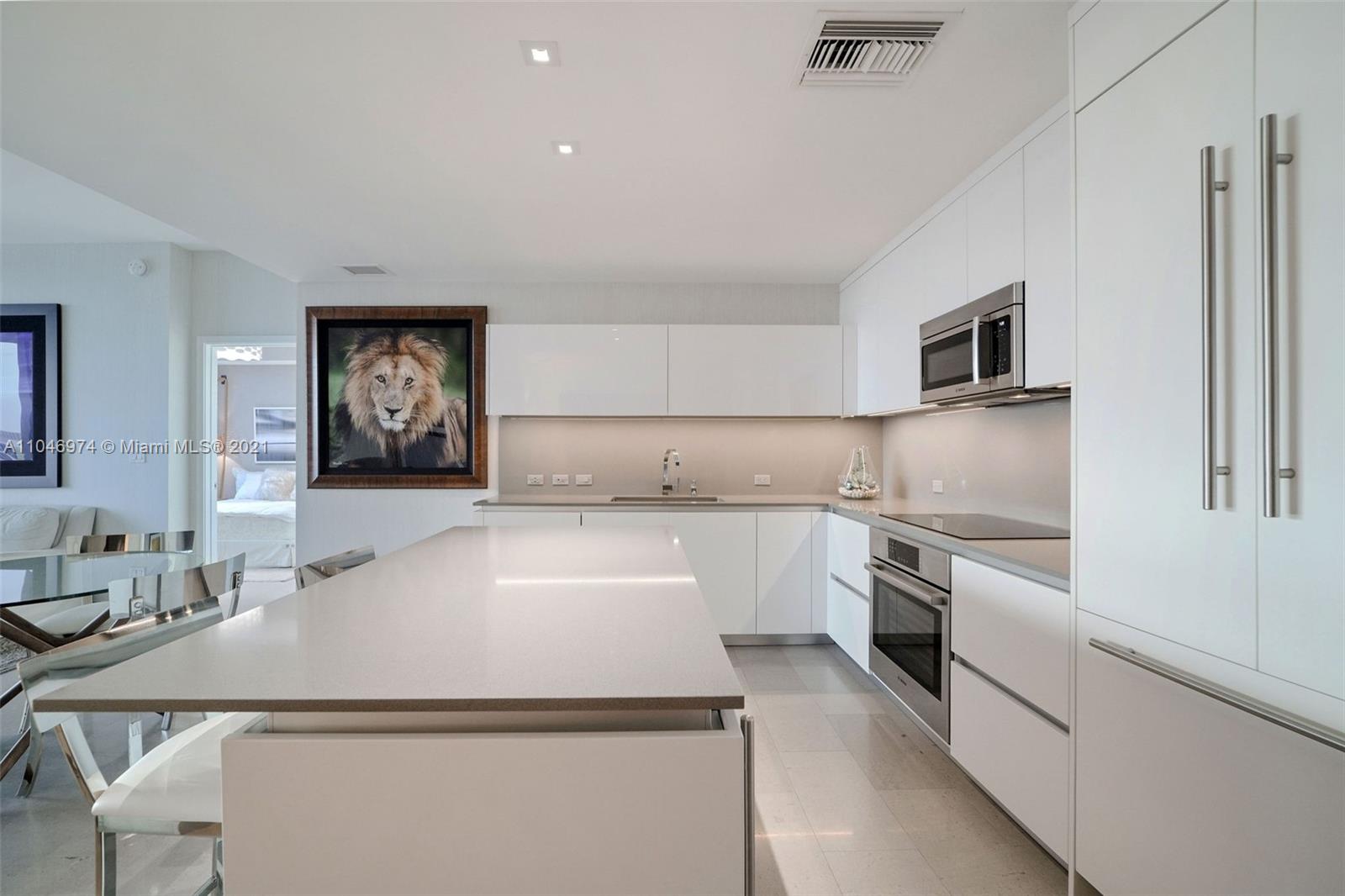 88 Southwest 7th Street, Unit 1904 Miami, FL 33130 - Photo 4 of 28 a kitchen with granite countertop a sink stainless steel appliances and cabinets