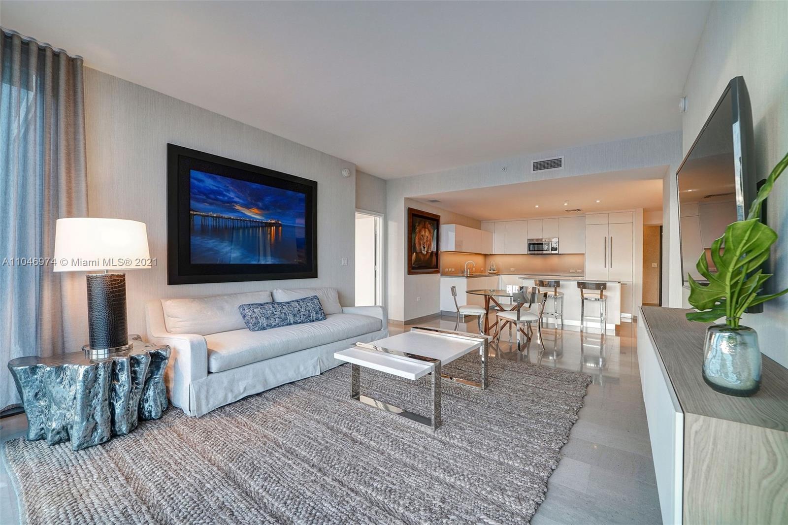 88 Southwest 7th Street, Unit 1904 Miami, FL 33130 - Photo 8 of 28 a living room with furniture and a flat screen tv