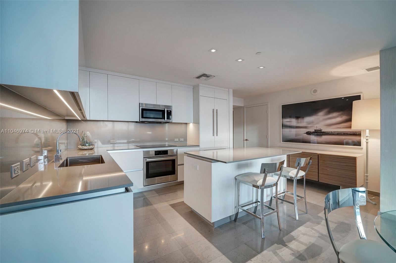 88 Southwest 7th Street, Unit 1904 Miami, FL 33130 - Photo 9 of 28 a kitchen with a sink cabinets and stainless steel appliances