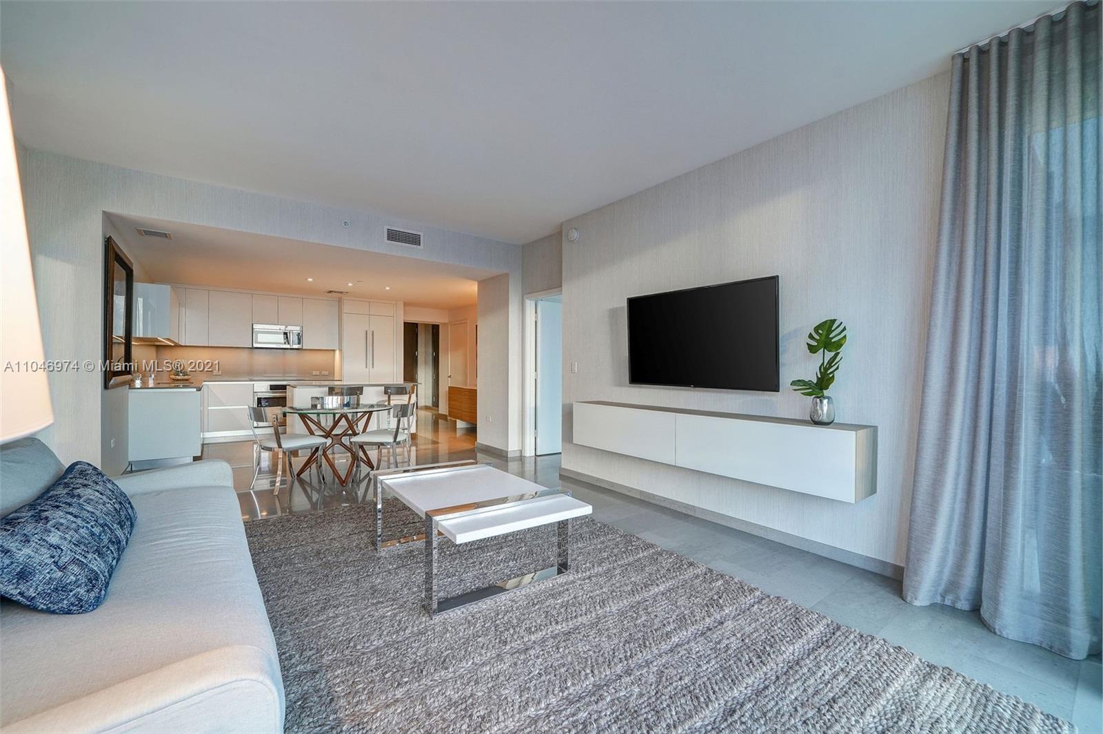 88 Southwest 7th Street, Unit 1904 Miami, FL 33130 - Photo 10 of 28 a living room with furniture and a flat screen tv