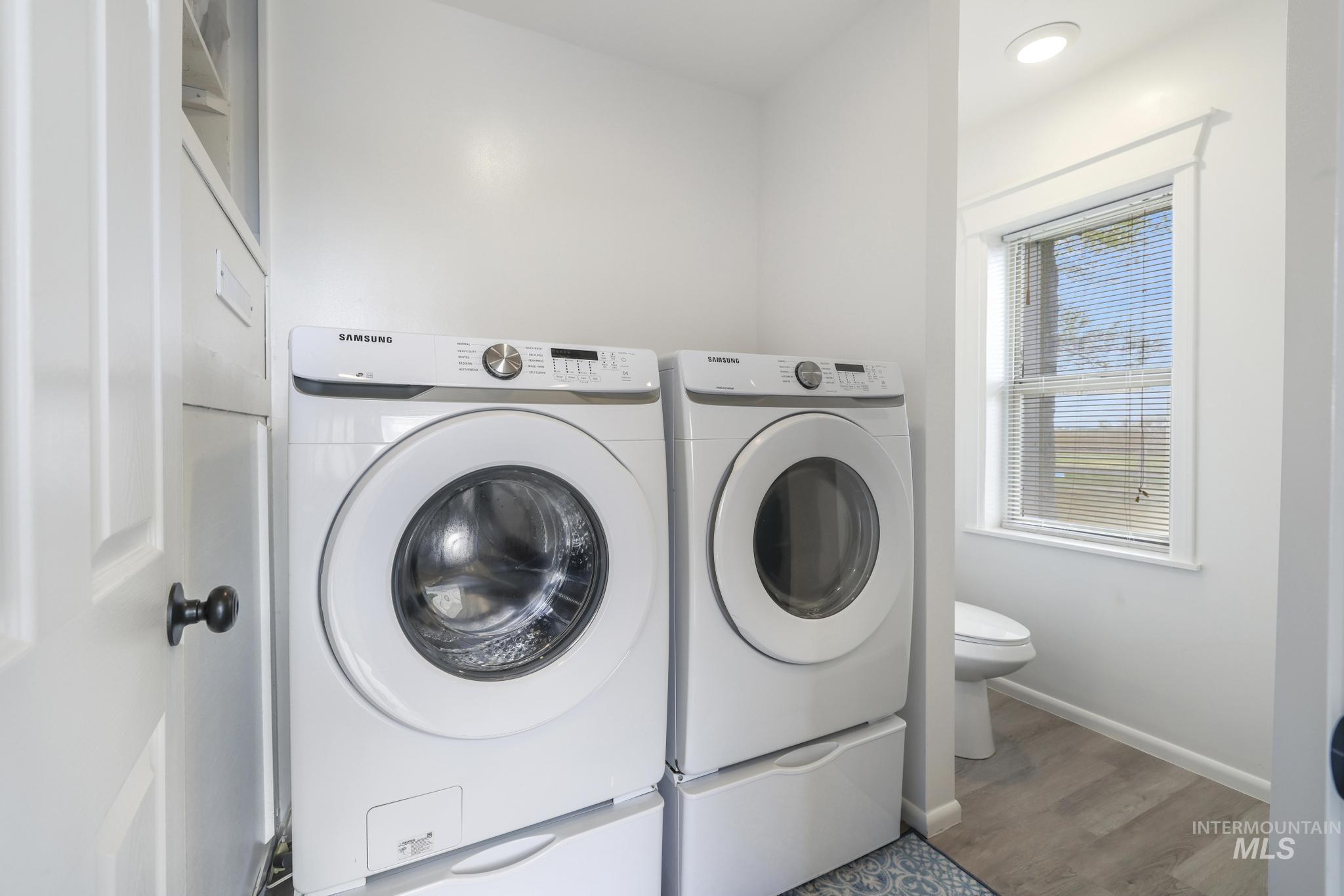 88 South 400 Road West Jerome, ID 83338 - Photo 26 of 31 Laundry area featuring washing machine and dryer and wood finished floors
