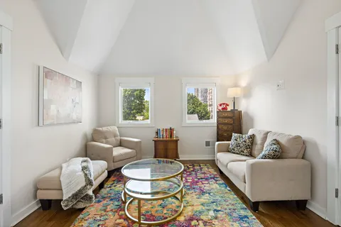 a living room with furniture and a rug