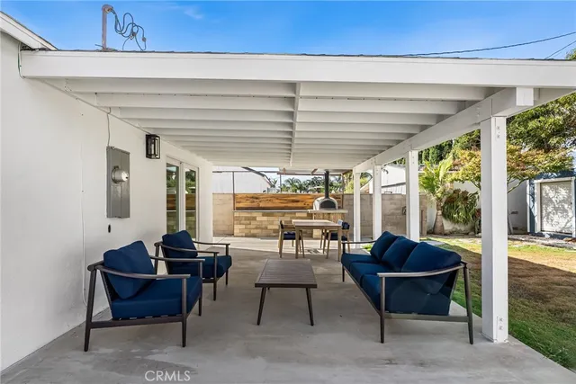 a living room with furniture and a floor to ceiling window