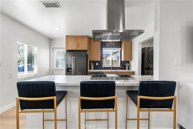 a kitchen with a dining table chairs and a chandelier