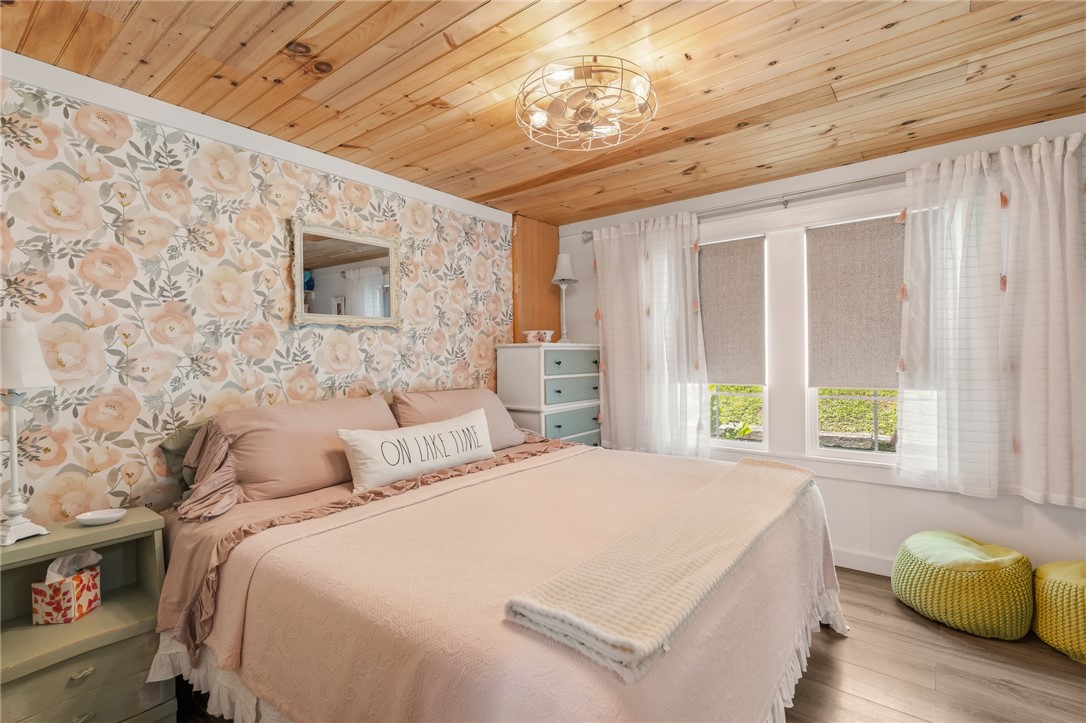 30 Mobleys Bluff Road Abbeville, SC 29620 - Photo 21 of 35 Natural wood ceilings and large windows create a cozy, warm atmosphere in this bedroom.