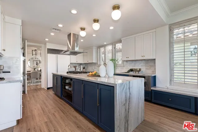 a kitchen with stainless steel appliances granite countertop a sink a stove and a refrigerator