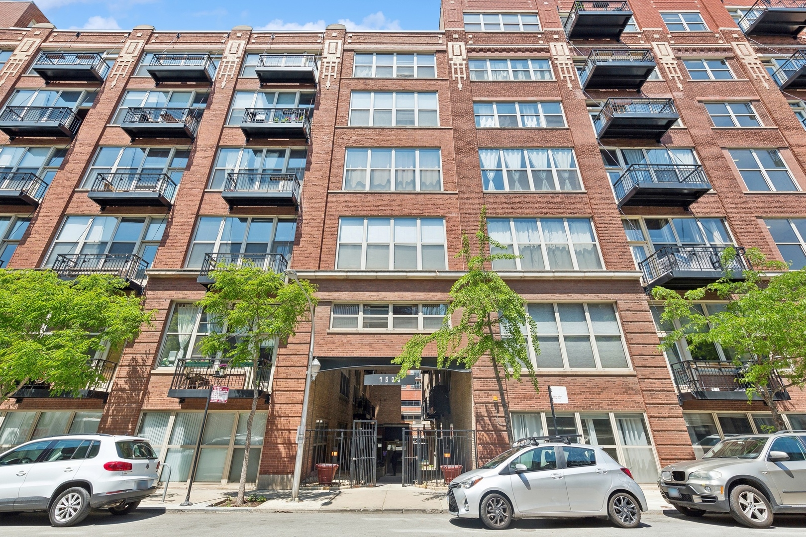 1500 West Monroe Street, Unit 306 Chicago, IL 60607 - Photo 2 of 13 a front view of a building with lot of cars and trees